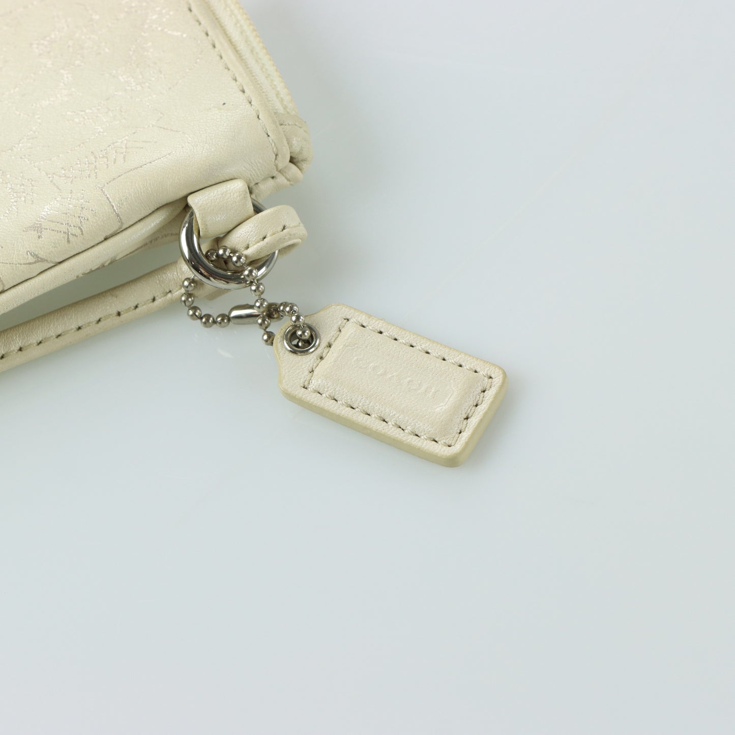 COACH Cream & Silver Rose Outline Wristlet